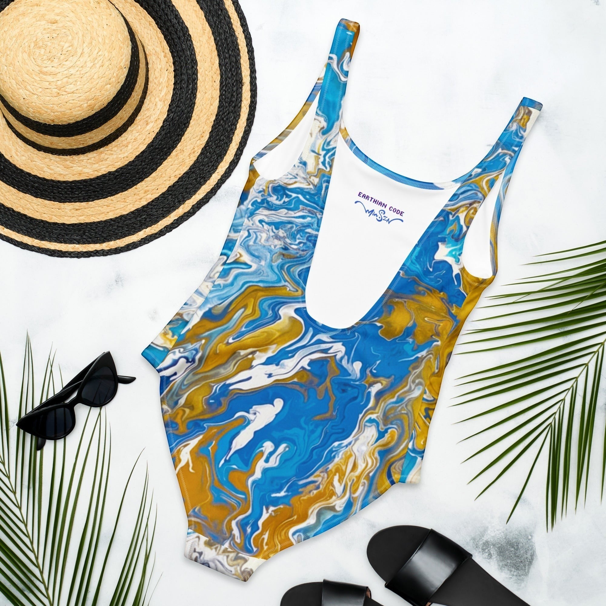My Store abstract harmony one-piece swimsuit in blue, gold, and white. Features a scoop neckline and low back.